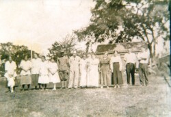 Recently, I was scanning a box of photographs that were on one of the tables in the basement of the schoolhouse as we are trying to digitize as much historical data as possible. I have a process where I scan the photograph, edit it to make it as clear as possible, and then rename the photo with whatever is written on the back. One of the photographs had a large group of people in it and I thought nothing of it until I was typing in the names - Martha, Elizabeth, Agnes, Helen, Hazel…Wait a minute! Those names sound familiar! My grandmother, Martha, had sisters with those names. Sure enough, as I went through the rest of the names, it was indeed members of the Richmond and Farquhar families and that WAS my grandmother in the picture. There was no date on the photograph, but one of my great uncles was wearing a uniform from World War I, or the Great War as it was referred to back then. Andrew Farquhar was in the picture with his wife, Marguerite Richmond Farquahar, and their first born son Donald who was born in July 1917. Andrew died on October 23, 1918 so this picture was taken sometime between July 1917 and October 1918. My grandmother was 17 or 18 years old in the picture, having been born on January 1, 1900, it was always very easy to figure out her age. No math needed. She later married John B. Scott, who was a selectman for the town of Norton for 27 years. John Scott Boulevard was named in his honor for his years of service to the town. One of the perks of working at the Norton Historical Society is having the pleasure of finding unexpected treasures such as a family picture taken over a hundred years ago that I might not have seen otherwise..
Pictured from left to right: Martha (my grandmother), unknown child, Elizabeth, Agnes, Hazel, Helen, and William Richmond along with Andy Farquhar, wife Marguerite, Mother Richmond with baby Donald Farquhar, Nellie, Emily, Jimmie, and George Richmond.